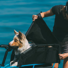 Load image into Gallery viewer, An image showing a dog sitting in a Yuba Wooftop carrier accessory on the rear of a Yuba longtail cargo bike.