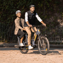Load image into Gallery viewer, A lifestyle image of the Yuba Compact AlloyBoards accessory for Yuba compact longtail cargo ebikes, showing a rear passenger on a Yuba cargo bike.