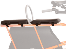 Load image into Gallery viewer, Two black padded seat cushions mounted on the rear rack of an electric cargo bike with a metal support bar in the center.