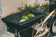 Load image into Gallery viewer, A product image of the Yuba Monkey Bars Tote accessory while carrying groceries.