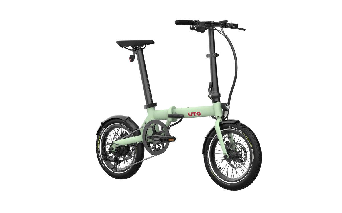 A compact folding electric bicycle in a light mint green frame with black components, including the wheels, saddle, handlebars, and tires. The brand name 'UTO' is printed in red on the down tube.