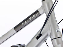 Load image into Gallery viewer, Close-up of Raleigh Captus electric bike frame showing mid-step design for urban e-bike commuting
