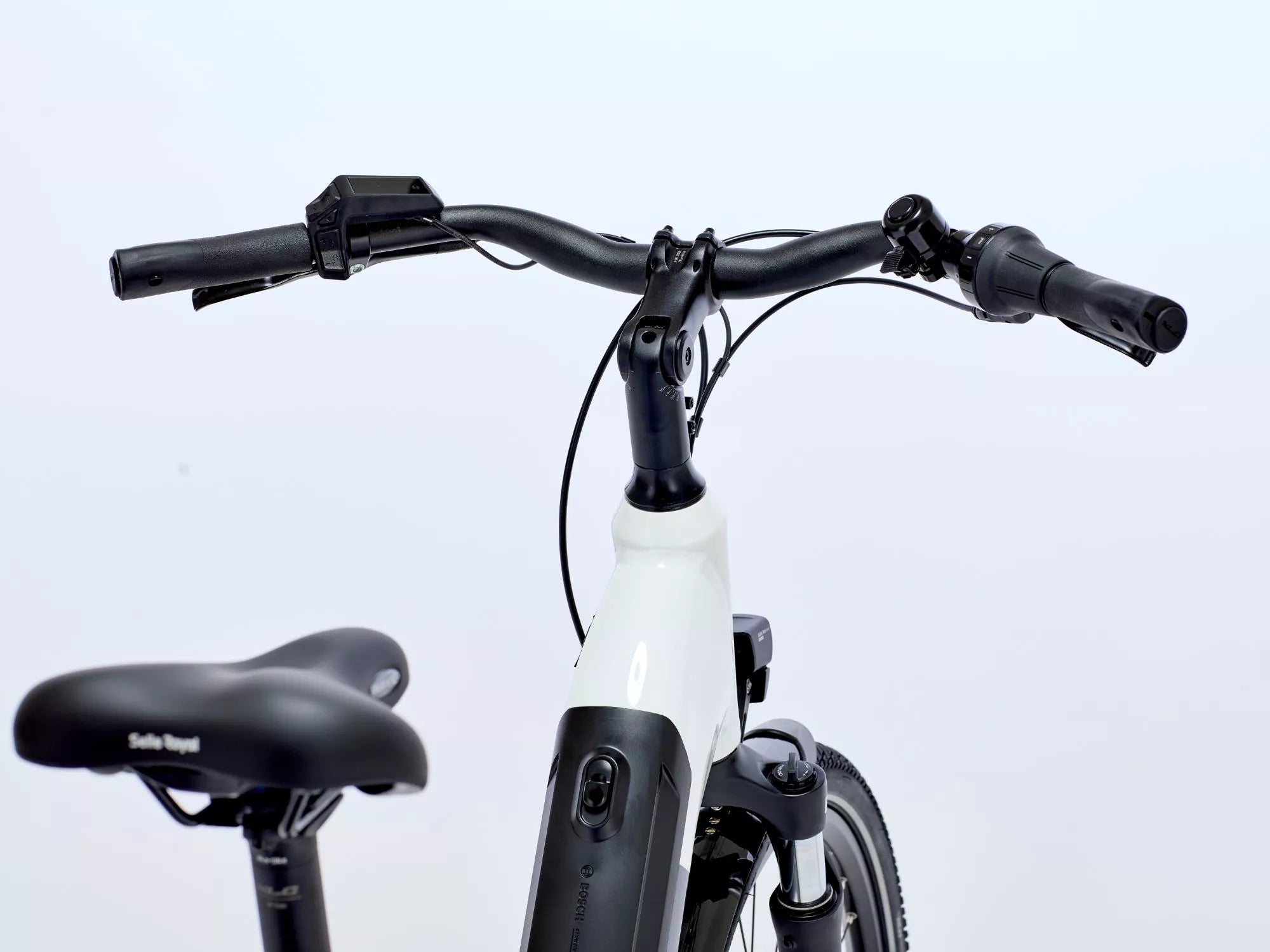 White electric bike with black handlebars and seat on a light gray background.