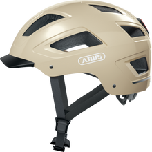Load image into Gallery viewer, A product image of the Abus Hyban 2.0 cycle safety helmet, showing the colour option for Cannoli Cream.
