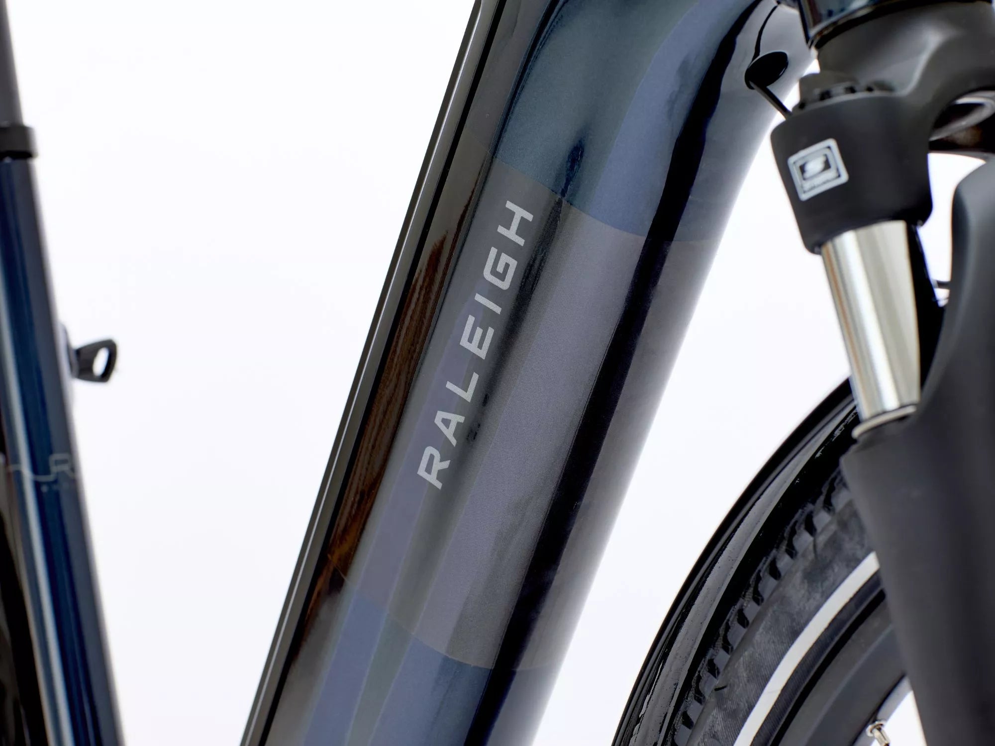 Close-up of an ebike fork with 'Raleigh' branding on a white background.