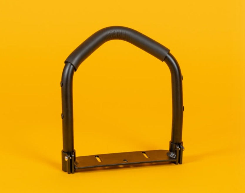 A black Yuba Crest handlebar accessory for cargo bikes displayed against an orange background.