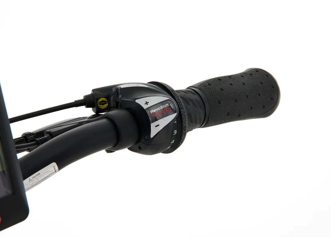 A product image of the Veloci Hopper folding electric bike from LeaseBike by Bleeper, showing a close-up of the gear shifting mechanisms on the right side of the handlebar. 