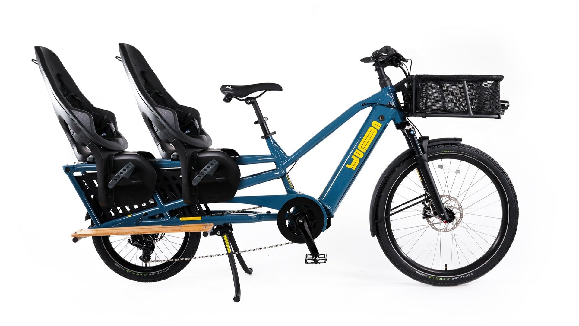 A product image of the Yuba Spicy Curry V4 electric longtail cargo bike. The frame colour is True Blue and the bike is set up with two rear child seat add-ons and a front bread basket.. 