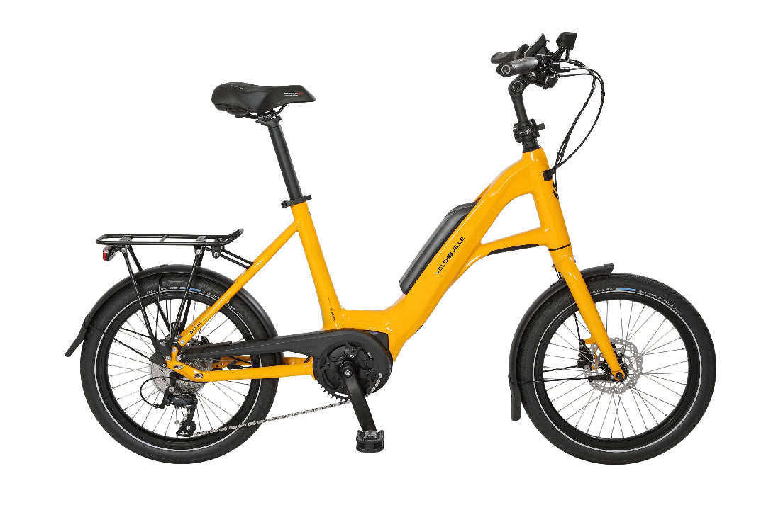 A product image of the VELO DE VILLE KEB compact electric bike, showing the Melon Yellow frame colour.