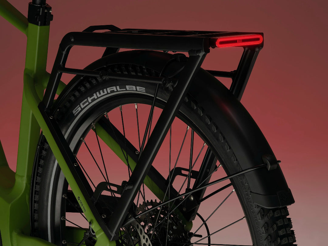 A close-up image showing the detail of the green frame colour and rear rack of a VELO DE VILLE electric bike.