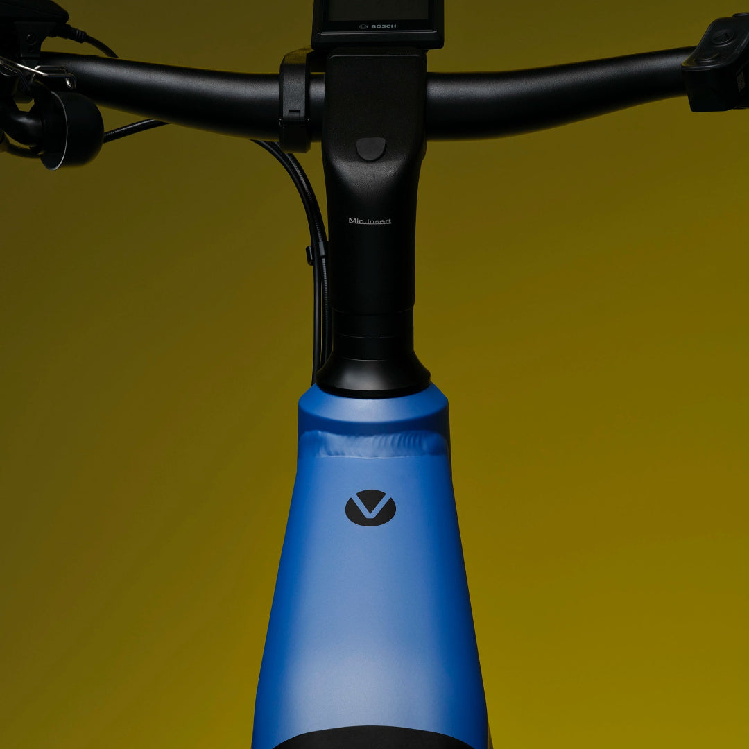 A close-up image showing the detail of the blue frame colour of a VELO DE VILLE electric bike.