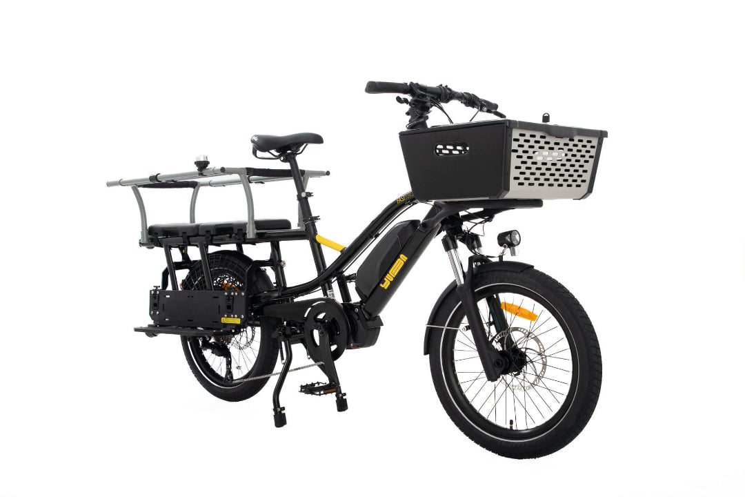 A product image of the Yuba Fastrack electric longtail cargo bike, showing the Espresso frame colour option. The Pot front basket and Monkey Bars seat accessories are shown attached to the bike. 