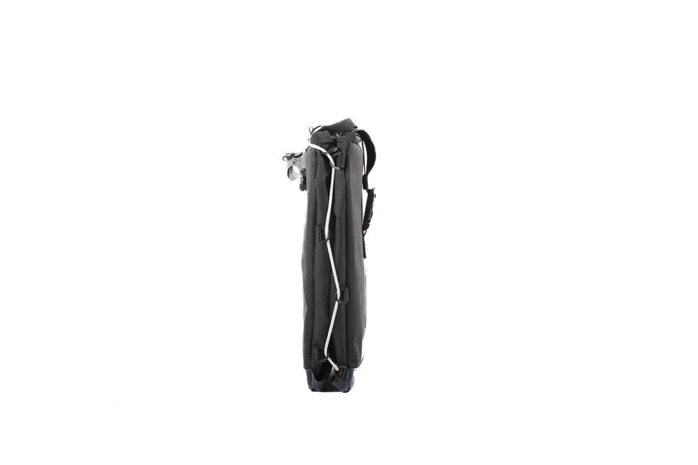 A product image showing the Yuba Eco Baguette bike bag in its folded down position, displaying a narrow profile. 