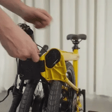 Load image into Gallery viewer, An animated gif showing the process for removing the integrated battery from the frame of the Ahooga Max folding electric bike. The battery sits inside the frame of the bike and can be fully removed to be charge. The battery can also be charged while it is still inside the frame of the bike.
