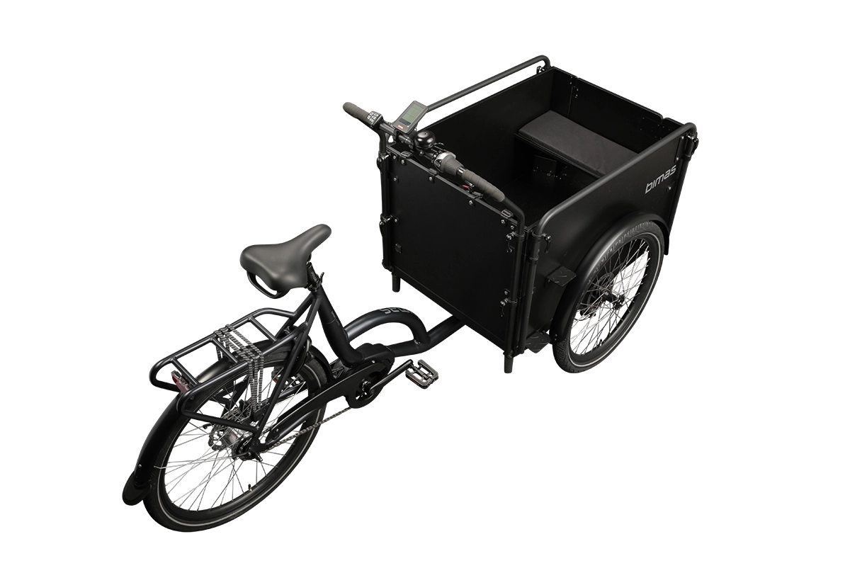 Product image of the Bimas eCargo 3.3 Premium electric cargo bike, shown from the right hand side. The bike frame and cargo box are both black. The photo is taken from an overhead angle to the rear of the cargo bike.
