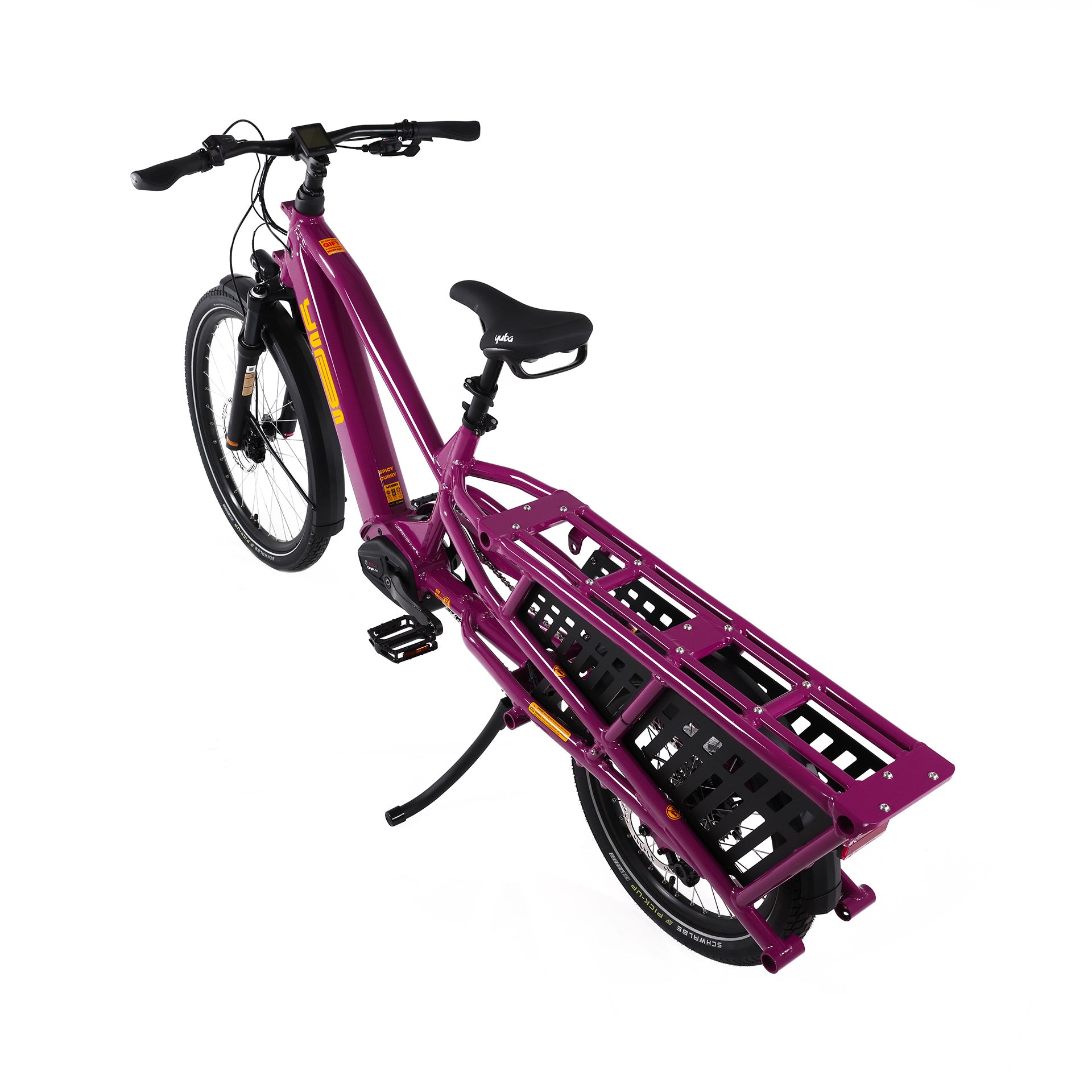 A product image of the Yuba Spicy Curry V4 electric bike taken from an overhead angle. The frame colour is Very Berry (a red grape colour) and the bike is in its basic set up, with no accessories attached. 