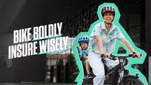 Load image into Gallery viewer, A photo of a woman cycling her bike with a child in the carrier on the back. The text overlaid on the photo reads, Bike Boldly, Insure Wisely
