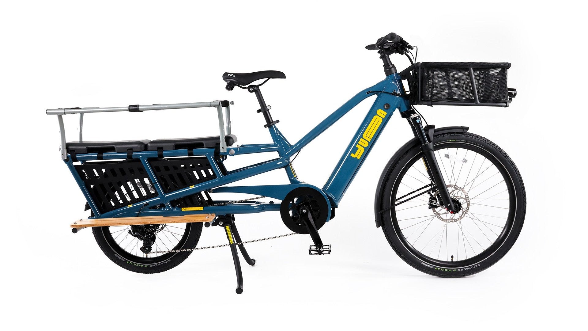 A product image of the Yuba Spicy Curry V4 electric longtail cargo bike. The frame colour is True Blue and the bike has a monkey bar add-on on the rear and a bread basket on the front.