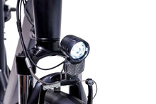 Load image into Gallery viewer, A product image of the Veloci Spirit electric bike from LeaseBike showing the detail of the integrated front white light, which is powered by the electric bike's battery.
