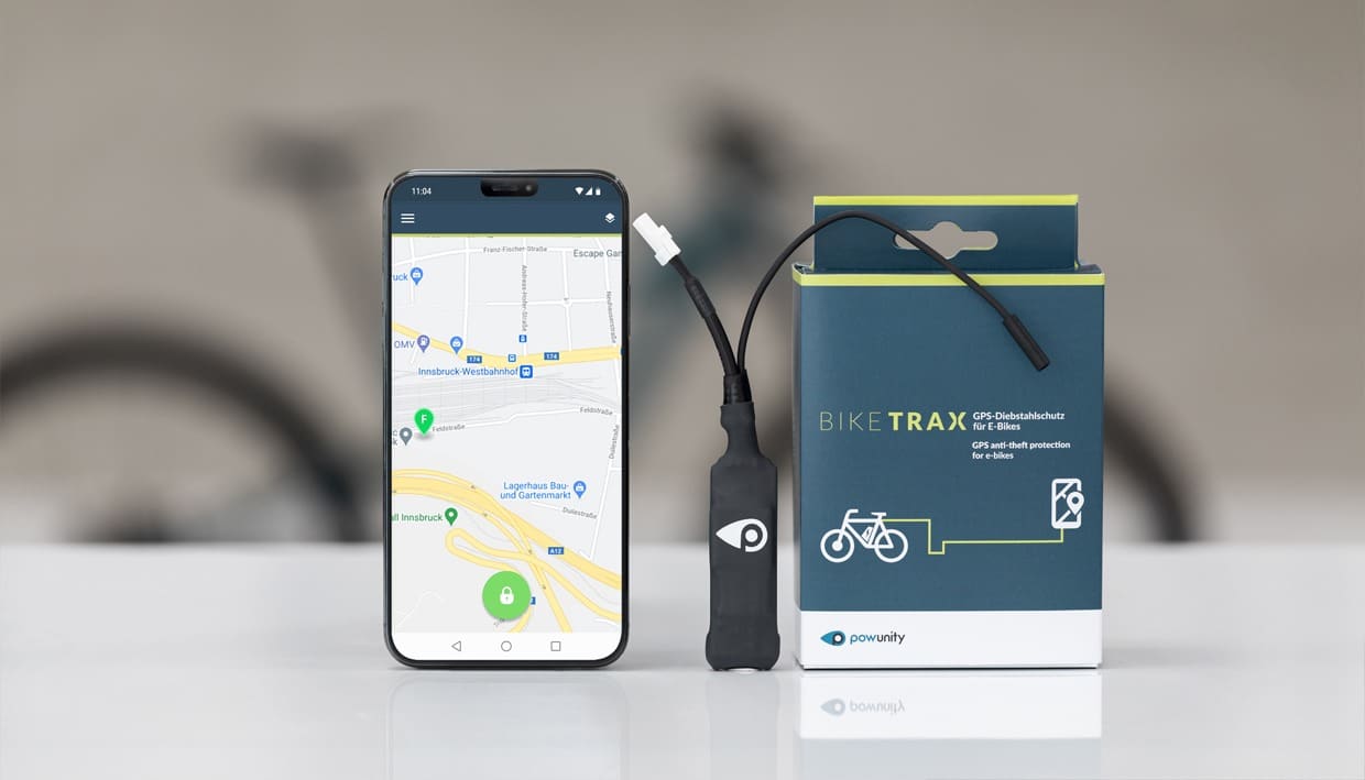 Black PowUnity BikeTrax GPS tracker with attached cable and battery pack, designed for discreet e-bike theft protection.